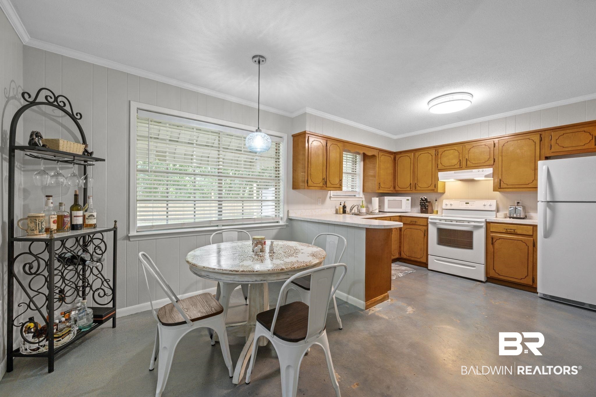621 Ann Street Saraland, AL 36571 - Photo 5 of 21 Kitchen featuring decorative light fixtures, white appliances, concrete floors, and ornamental molding