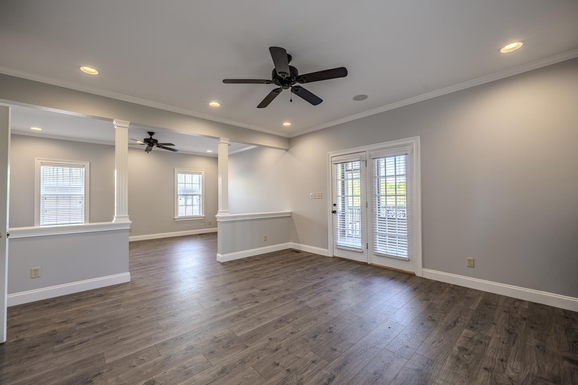 9 Mountain View Iuka, MS 38852 - Photo 13 of 32 Spare room with decorative columns, ceiling fan, plenty of natural light, dark wood-style floors, and recessed lighting