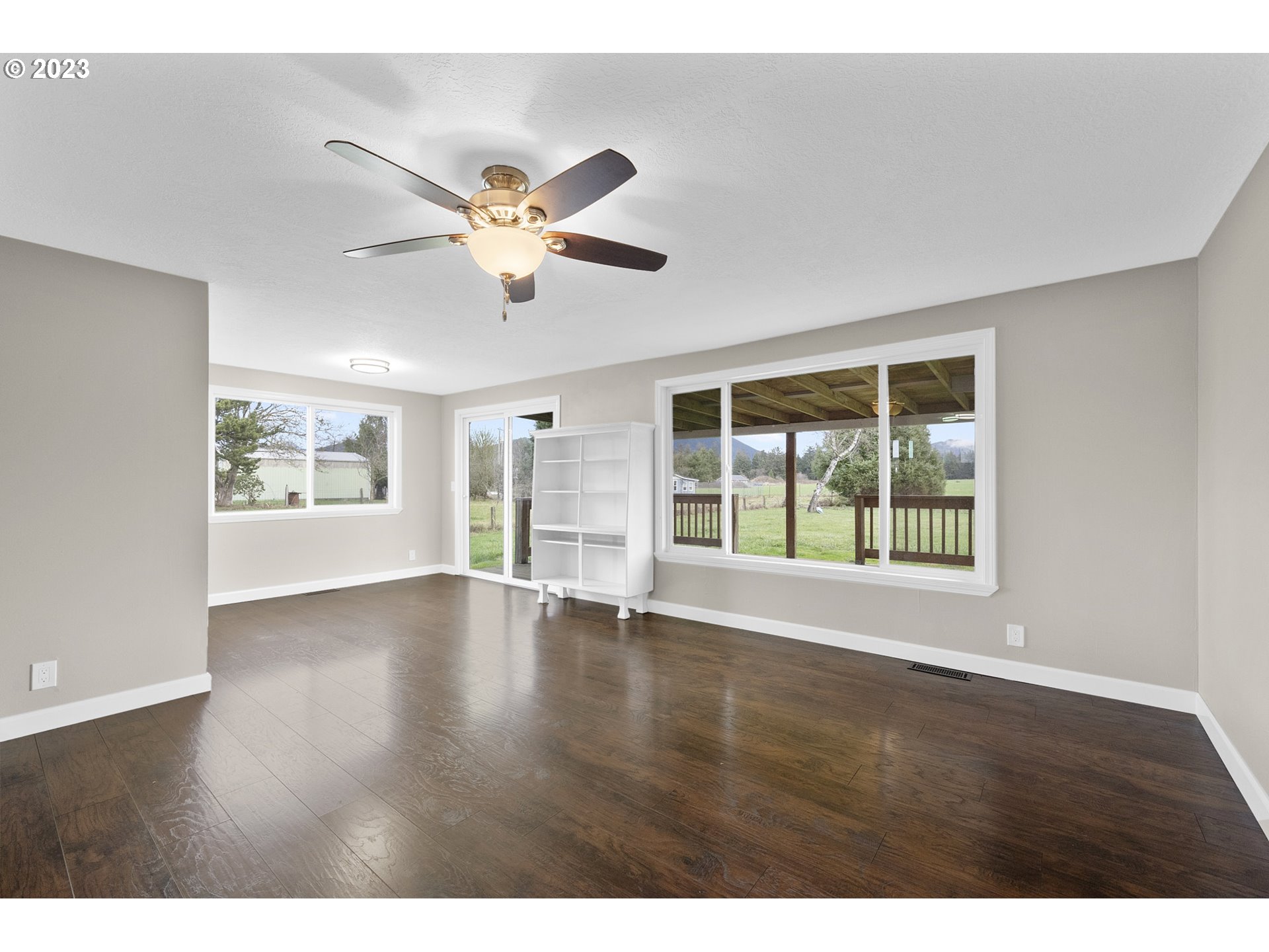 4175 Brickyard Road Tillamook, OR 97141 - Photo 8 of 20 a view of an empty room with wooden floor and a window