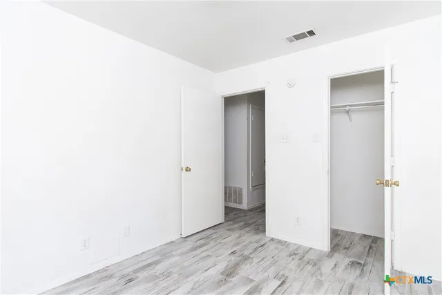 a view of hallway with wooden floor