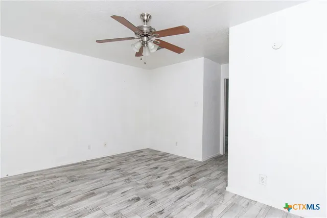 a view of a big room with wooden floor and closet