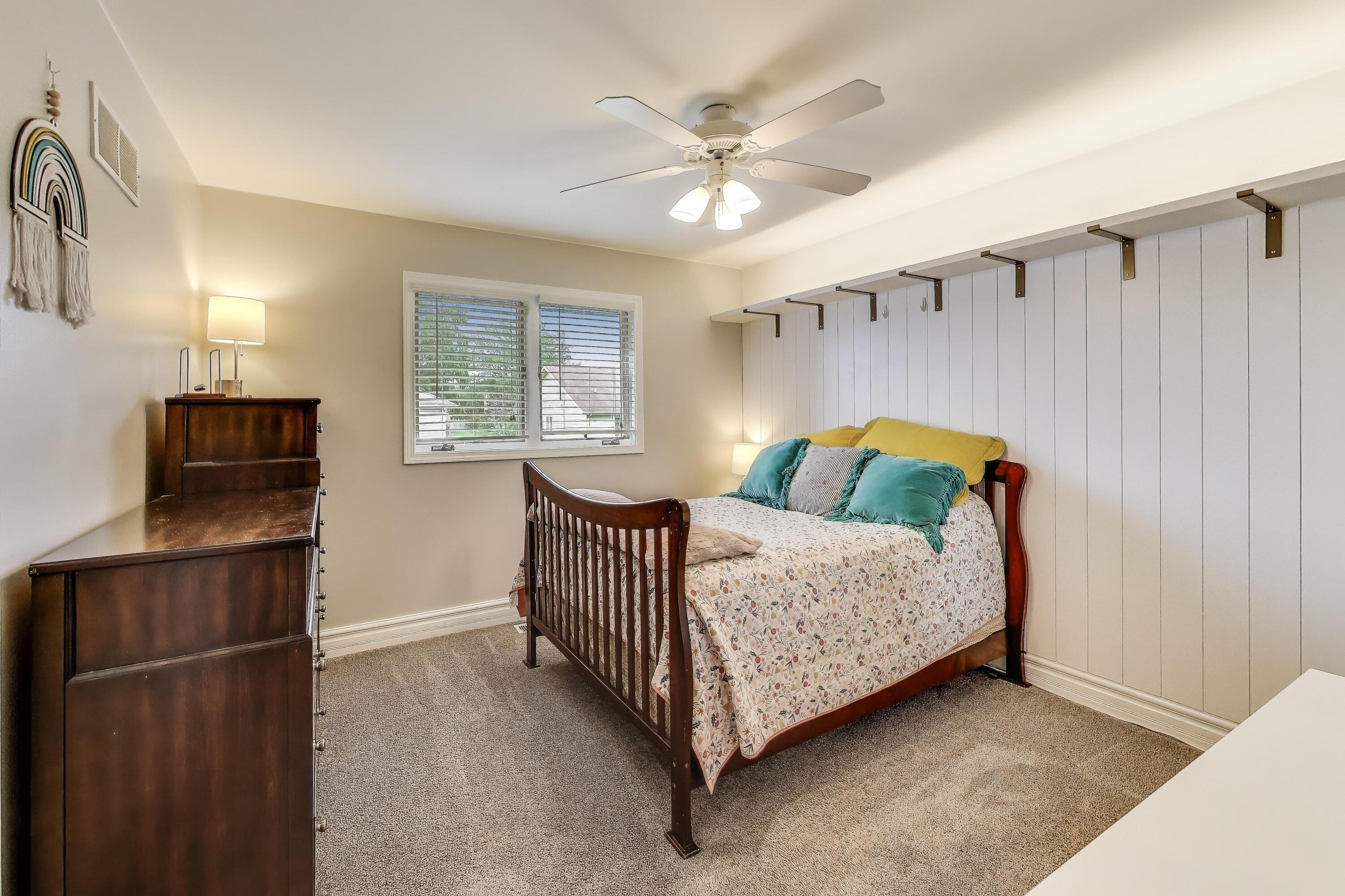 2903 Morningside Drive Crown Point, IN 46307 - Photo 16 of 39 a bedroom with a bed and a chandelier