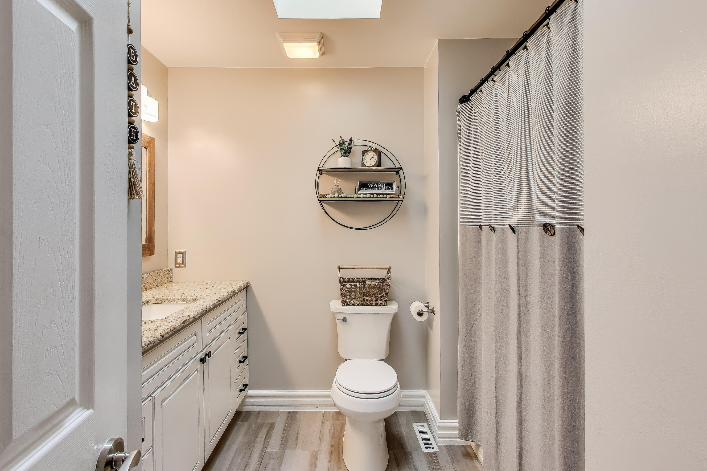 2903 Morningside Drive Crown Point, IN 46307 - Photo 18 of 39 a bathroom with a granite countertop toilet and a shower curtain