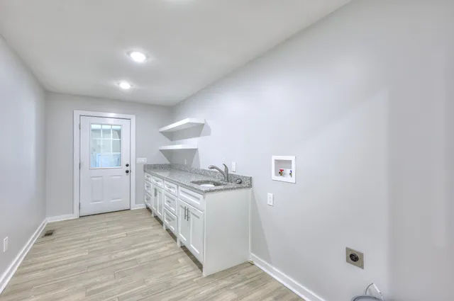 a kitchen with a stove and white cabinets