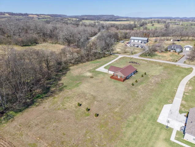 an aerial view of a house with outdoor space