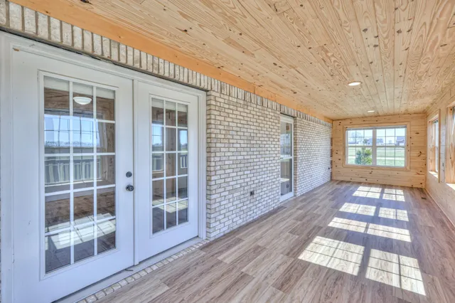 a view of an entryway with wooden floor and door