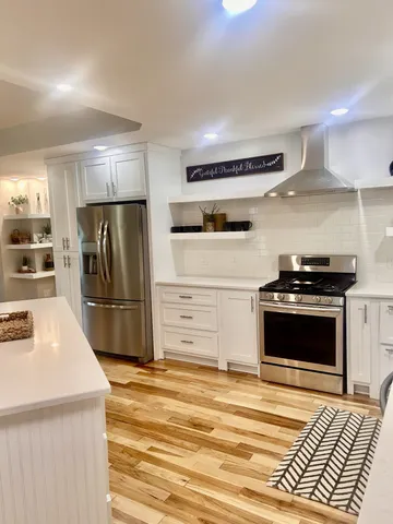 a kitchen with a refrigerator and a stove