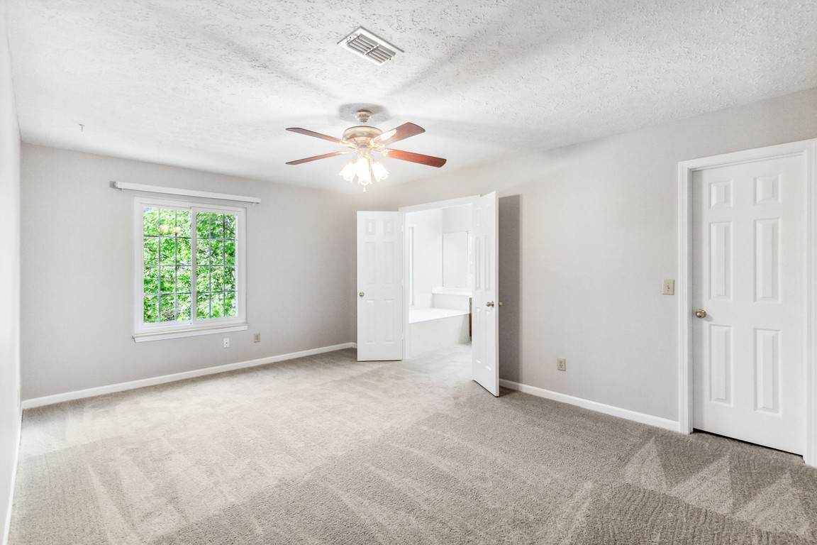 4105 New Hope Meadow Road Hermitage, TN 37076 - Photo 14 of 45 an empty room with windows and chandelier fan