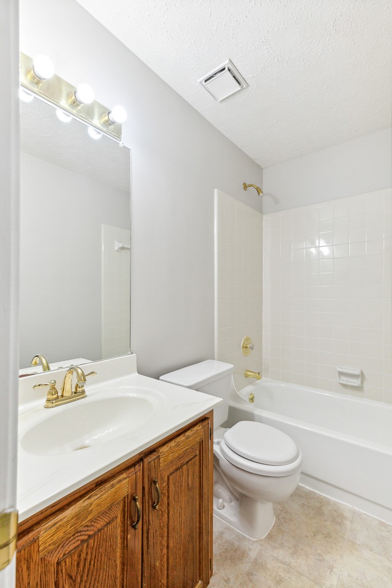 4105 New Hope Meadow Road Hermitage, TN 37076 - Photo 20 of 45 a bathroom with a granite countertop sink a toilet and shower