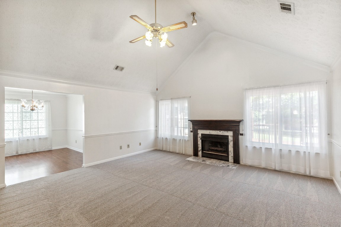 4105 New Hope Meadow Road Hermitage, TN 37076 - Photo 9 of 45 an empty room with fireplace cabinet and windows