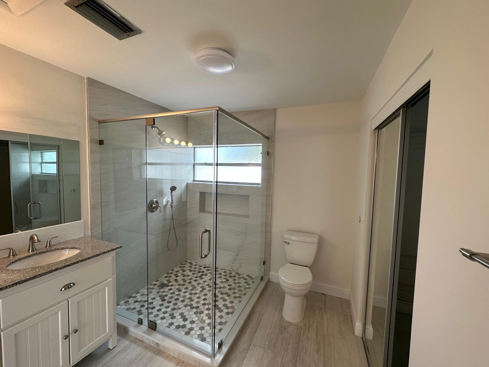 9841 Ridge Creek Road Boca Raton, FL 33496 - Photo 11 of 24 a bathroom with a shower toilet and sink
