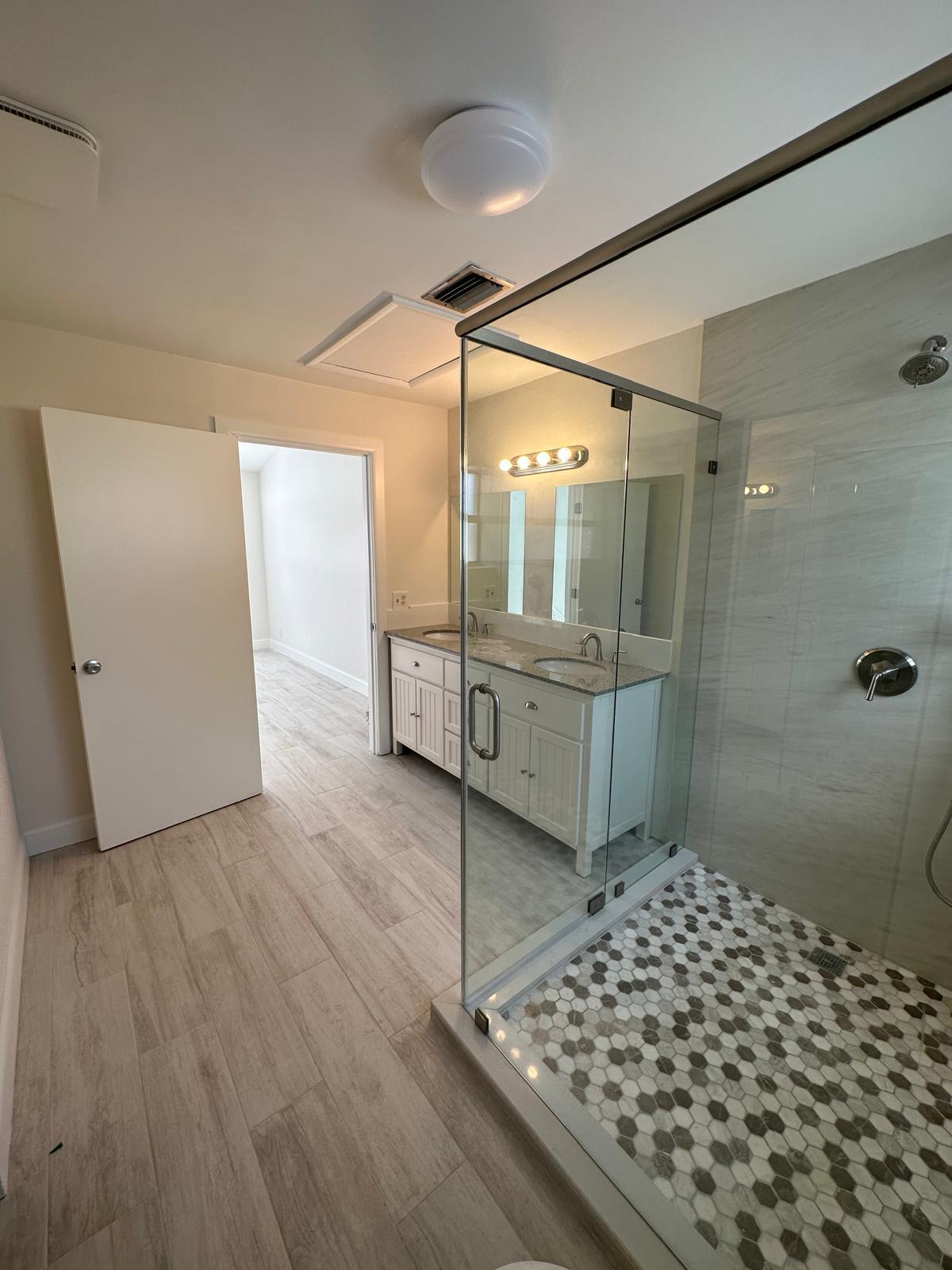 9841 Ridge Creek Road Boca Raton, FL 33496 - Photo 12 of 24 a bathroom with a glass shower door and a bathtub