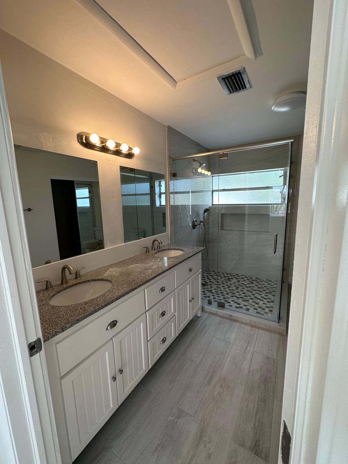 9841 Ridge Creek Road Boca Raton, FL 33496 - Photo 13 of 24 a bathroom with a double vanity sink and a mirror