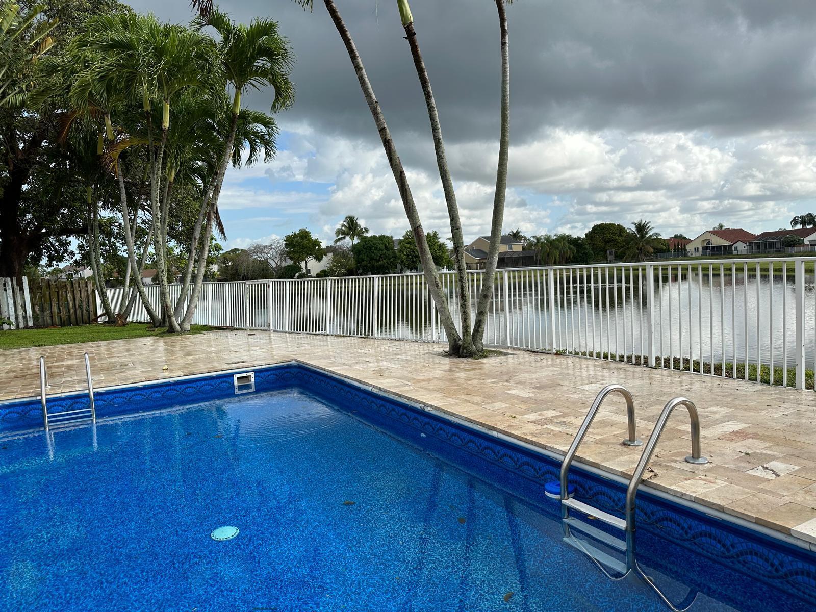 9841 Ridge Creek Road Boca Raton, FL 33496 - Photo 2 of 24 a view of a lake with couches chairs