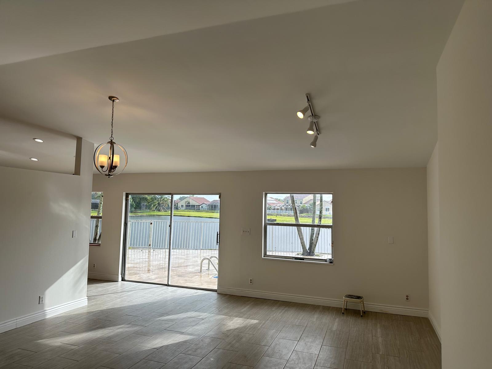 9841 Ridge Creek Road Boca Raton, FL 33496 - Photo 21 of 24 an empty room with windows and outdoor view