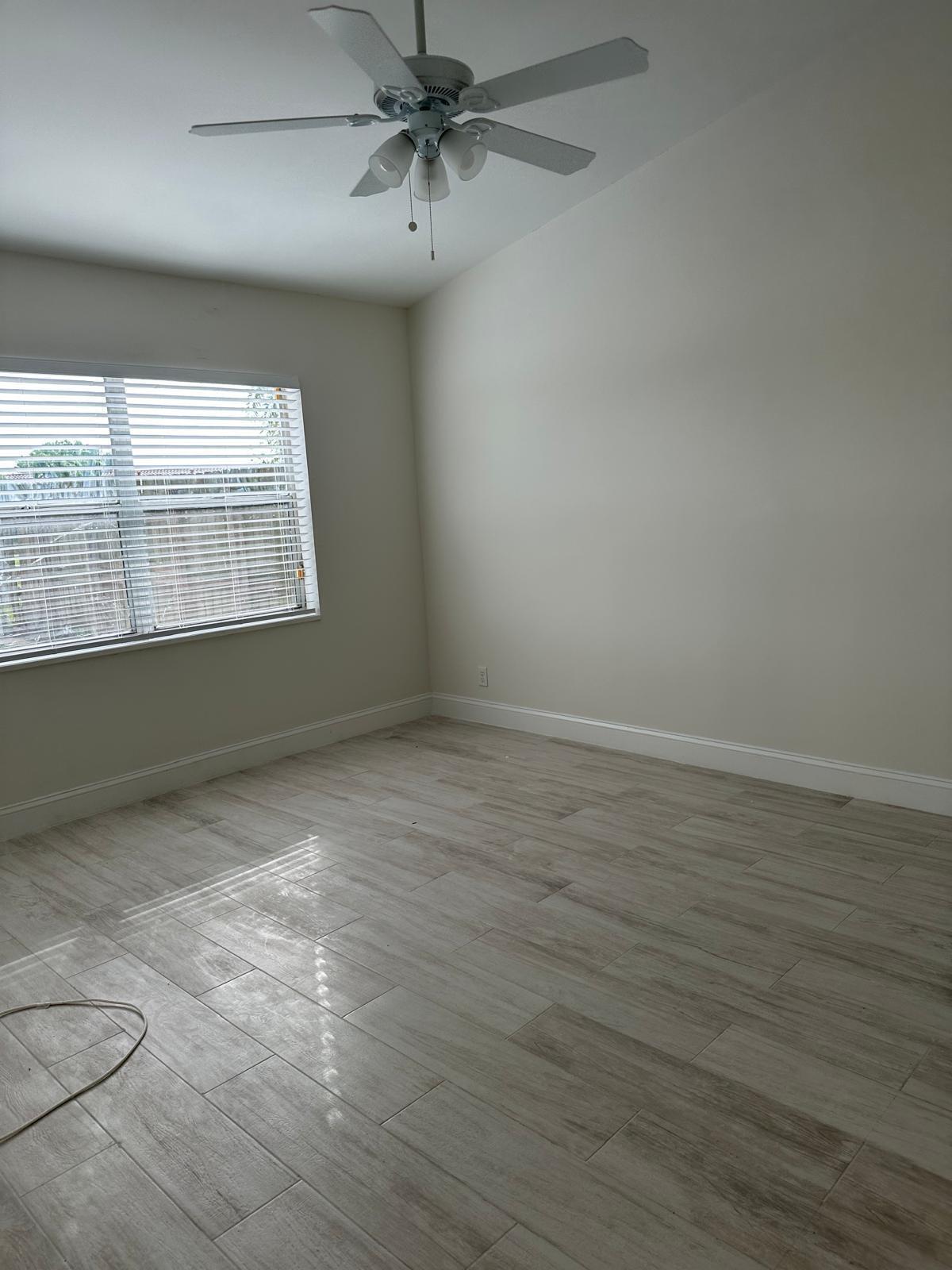 9841 Ridge Creek Road Boca Raton, FL 33496 - Photo 24 of 24 wooden floor in an empty room with a window