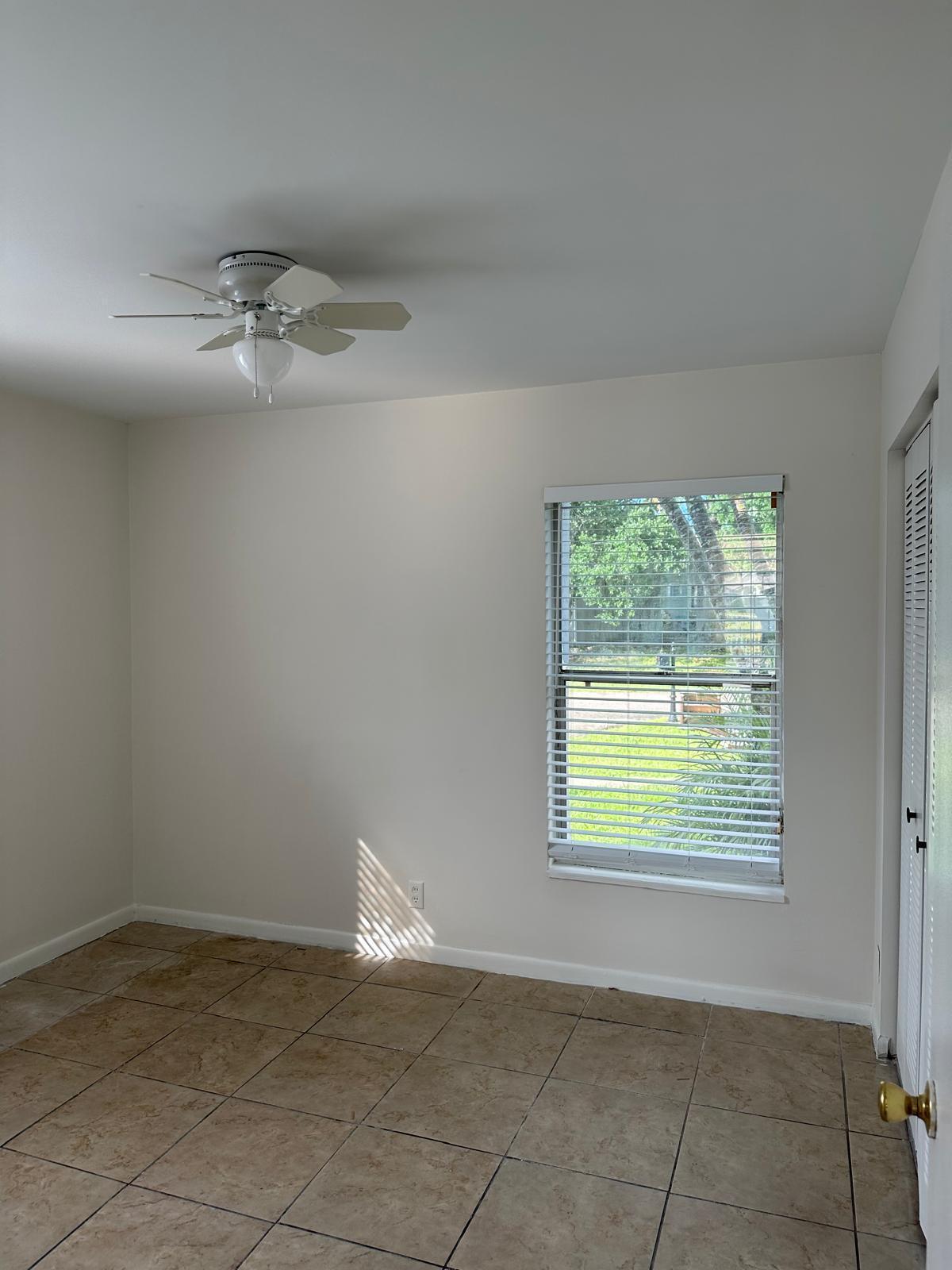 9841 Ridge Creek Road Boca Raton, FL 33496 - Photo 8 of 24 an empty room with a window