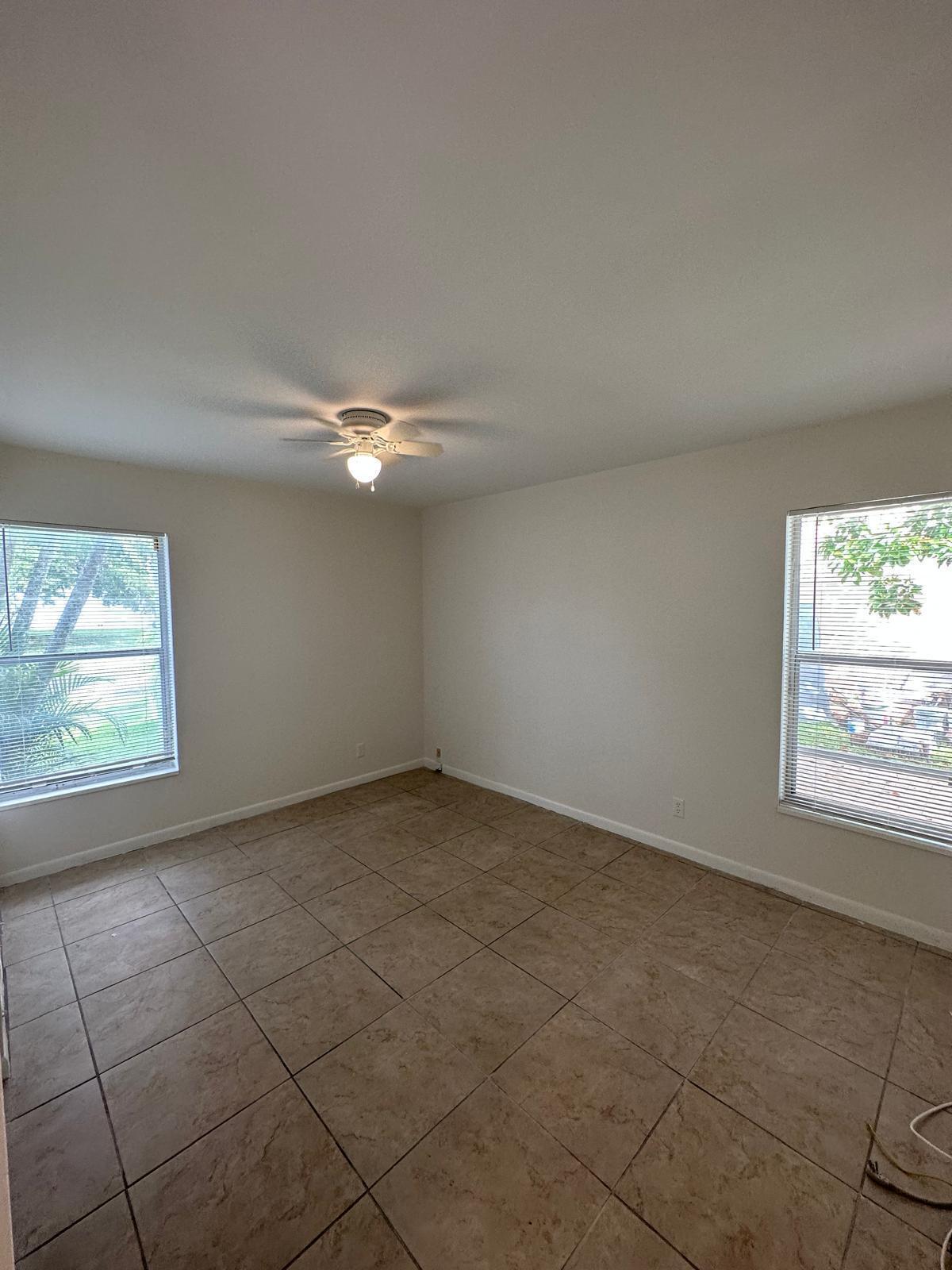 9841 Ridge Creek Road Boca Raton, FL 33496 - Photo 9 of 24 an empty room with a empty space and windows