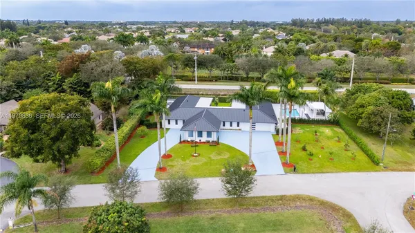 an aerial view of a swimming pool with a yard