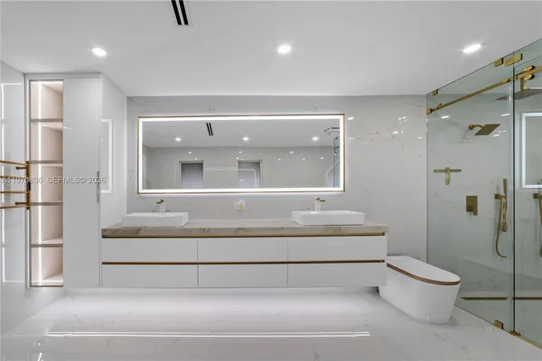 a bathroom with a toilet a sink and a shower