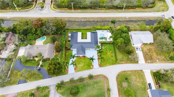 an aerial view of a house with a yard basket ball court and outdoor seating