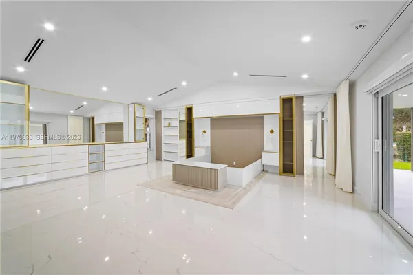 a large kitchen with a table and chairs