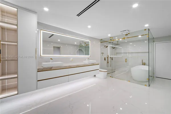 a kitchen with stainless steel appliances and white cabinets