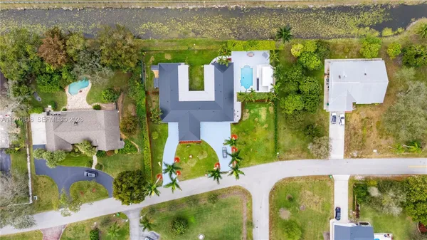 an aerial view of residential house with outdoor space and swimming pool