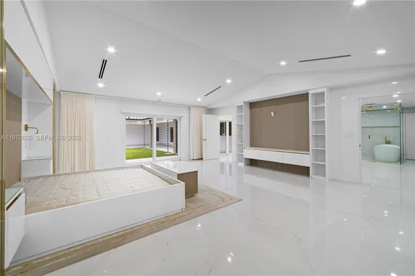 a kitchen with granite countertop white cabinets and appliances