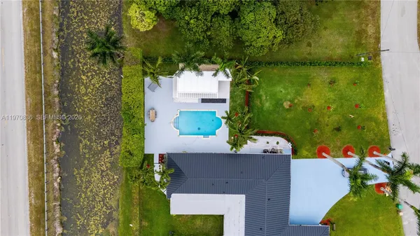 an aerial view of a house with a yard basket ball court and outdoor seating