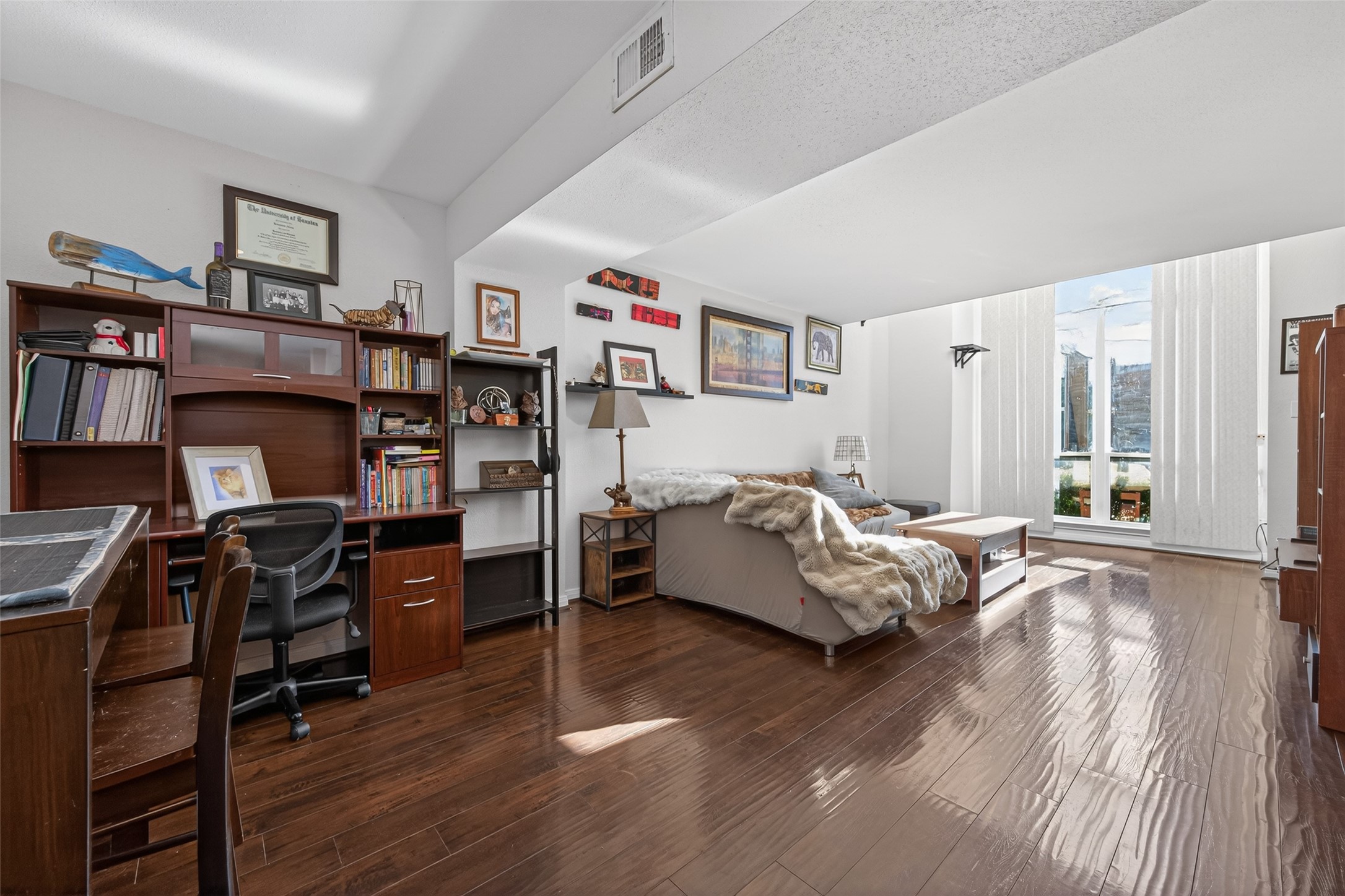 a bedroom with furniture and a wooden floor