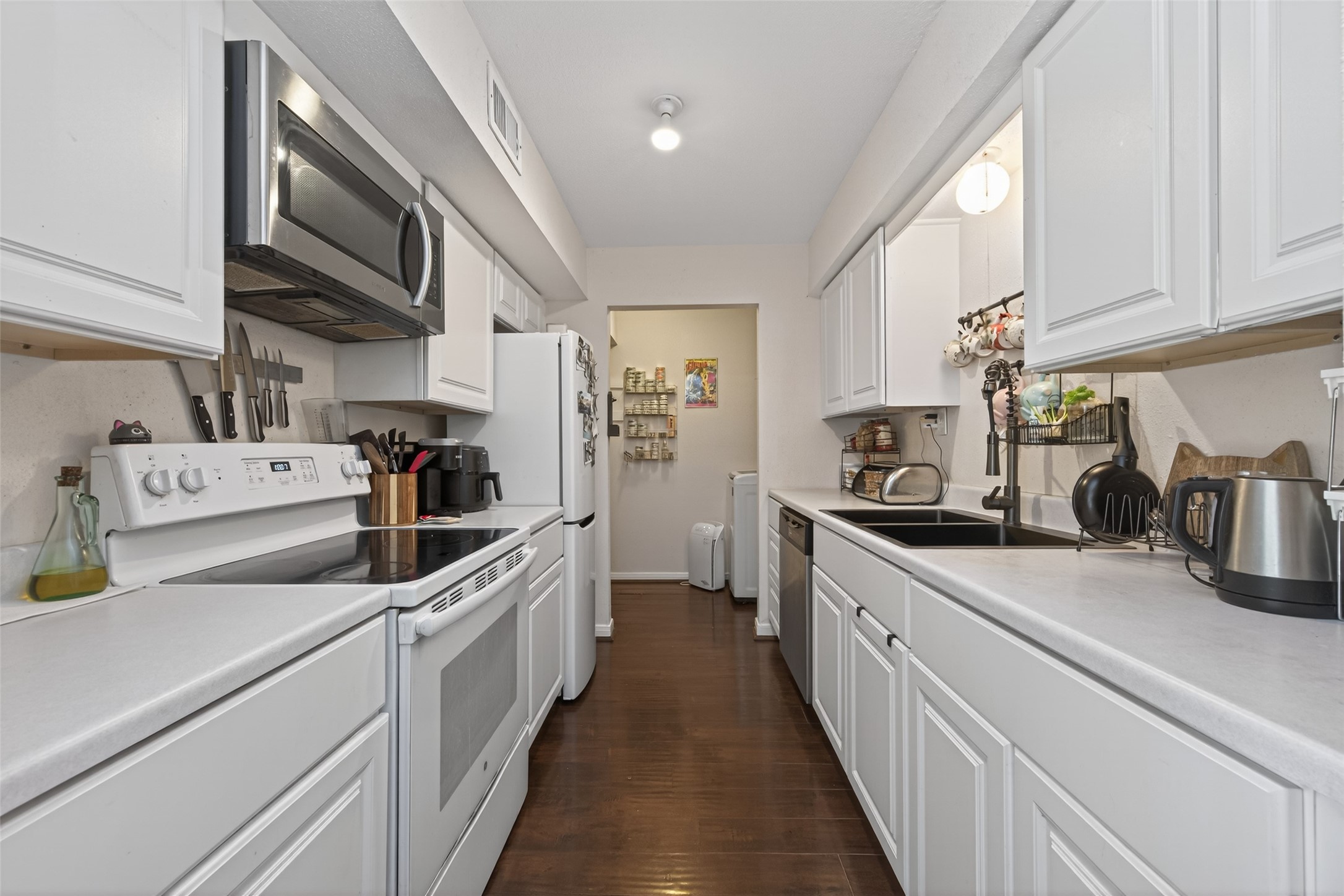 16120 Stuebner Airline Road, Unit 602 Spring, TX 77379 - Photo 19 of 50 a kitchen with stainless steel appliances sink microwave and cabinets