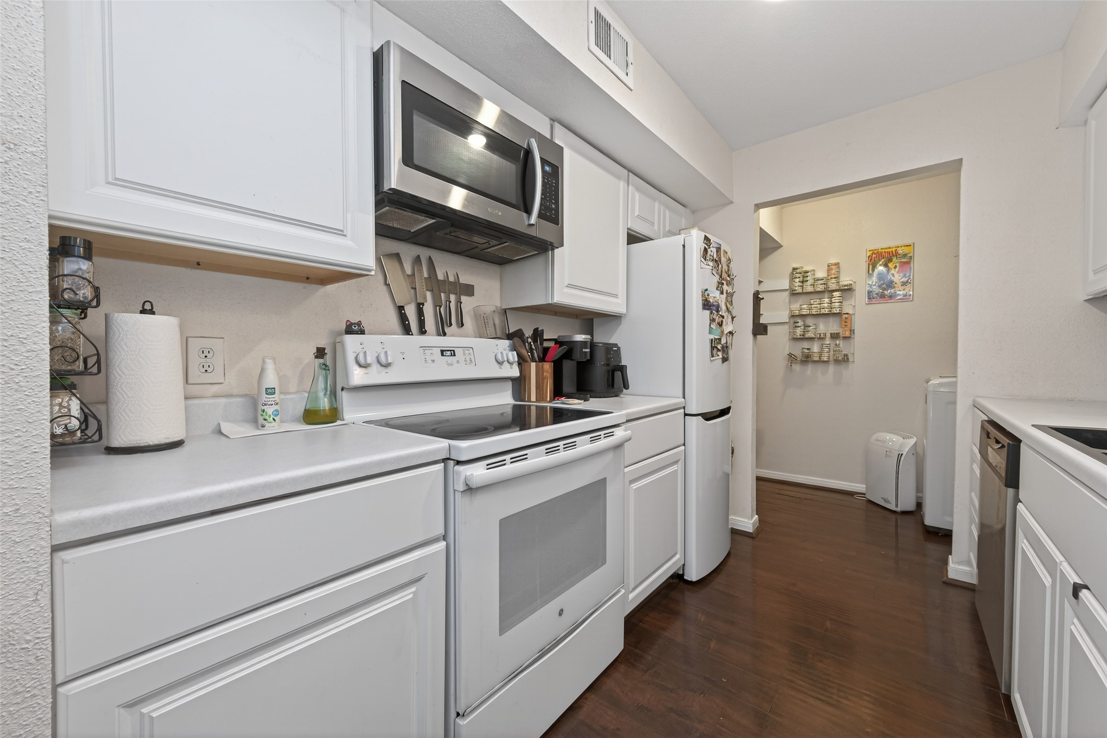 16120 Stuebner Airline Road, Unit 602 Spring, TX 77379 - Photo 20 of 50 a kitchen with stainless steel appliances white cabinets and a refrigerator