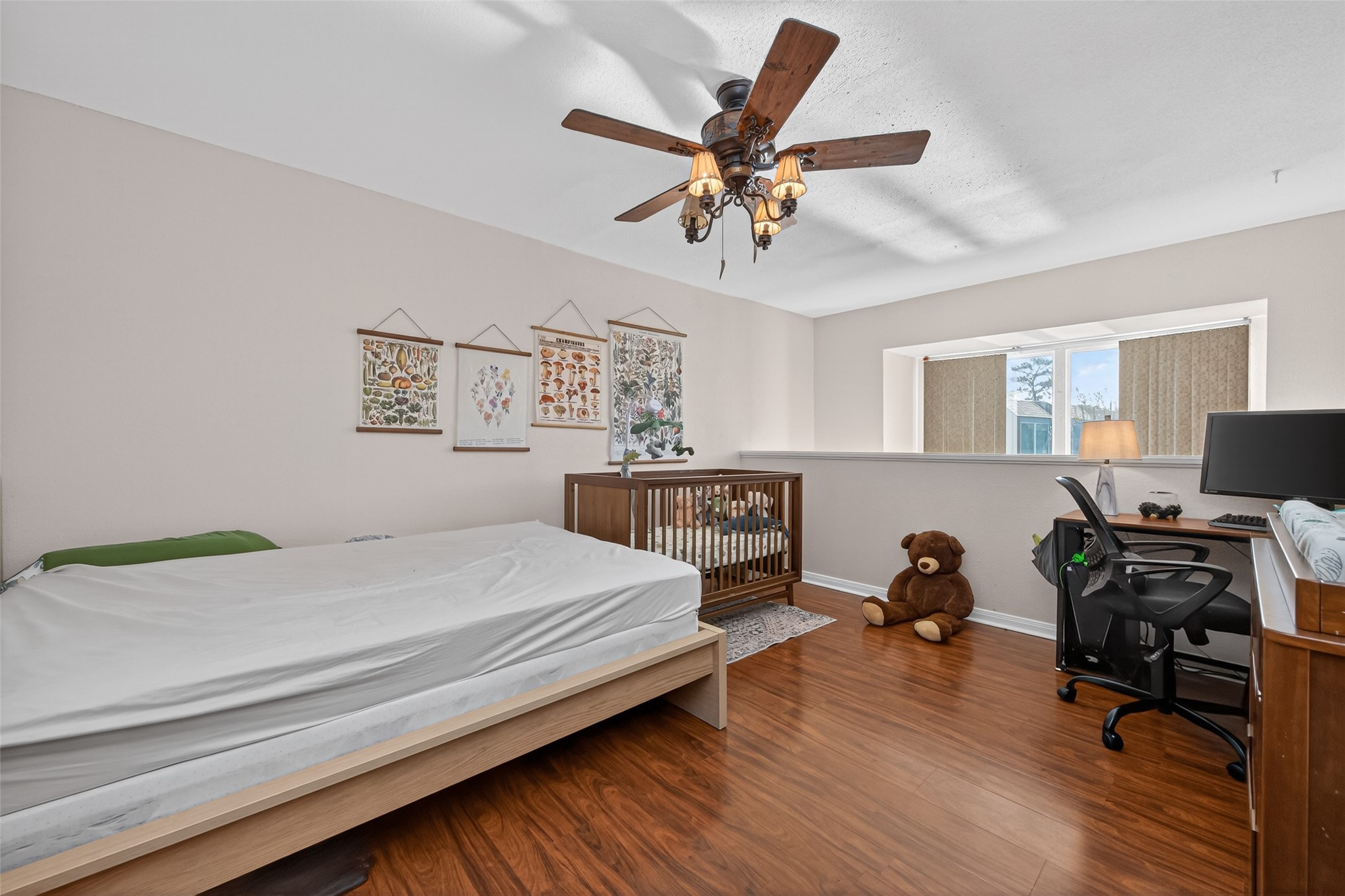 16120 Stuebner Airline Road, Unit 602 Spring, TX 77379 - Photo 30 of 50 a bedroom with a bed and a chandelier