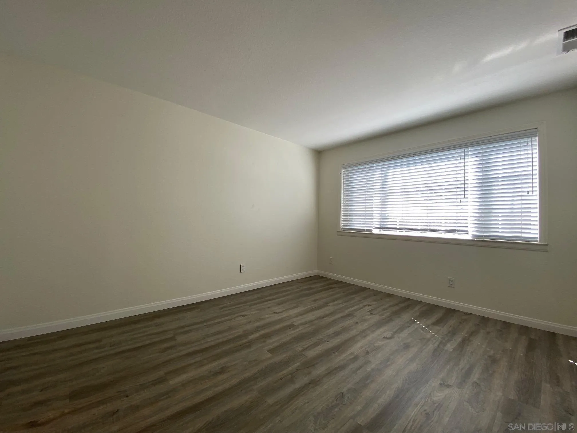 2848 Torrey Pines Road La Jolla, CA 92037 - Photo 13 of 19 a view of an empty room with wooden floor and a window