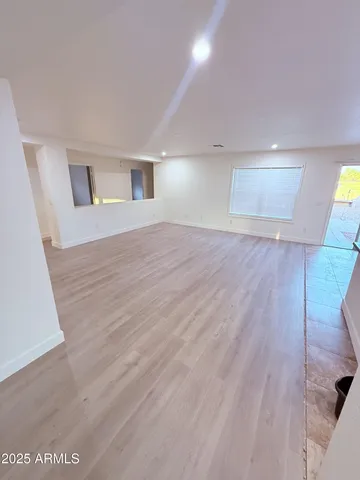 a view of an empty room and wooden floor