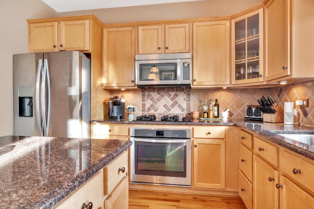 807 Sharp Court Elburn, IL 60119 - Photo 11 of 44 a kitchen with stainless steel appliances granite countertop a stove a sink and a refrigerator