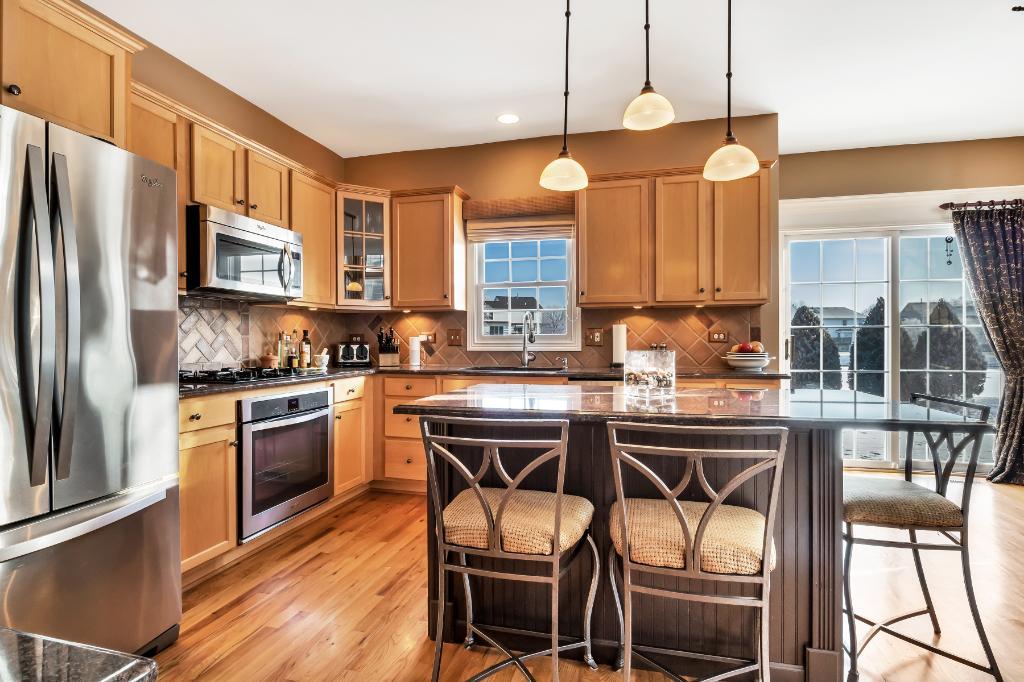 807 Sharp Court Elburn, IL 60119 - Photo 14 of 44 a kitchen with stainless steel appliances granite countertop a stove a sink refrigerator and a refrigerator