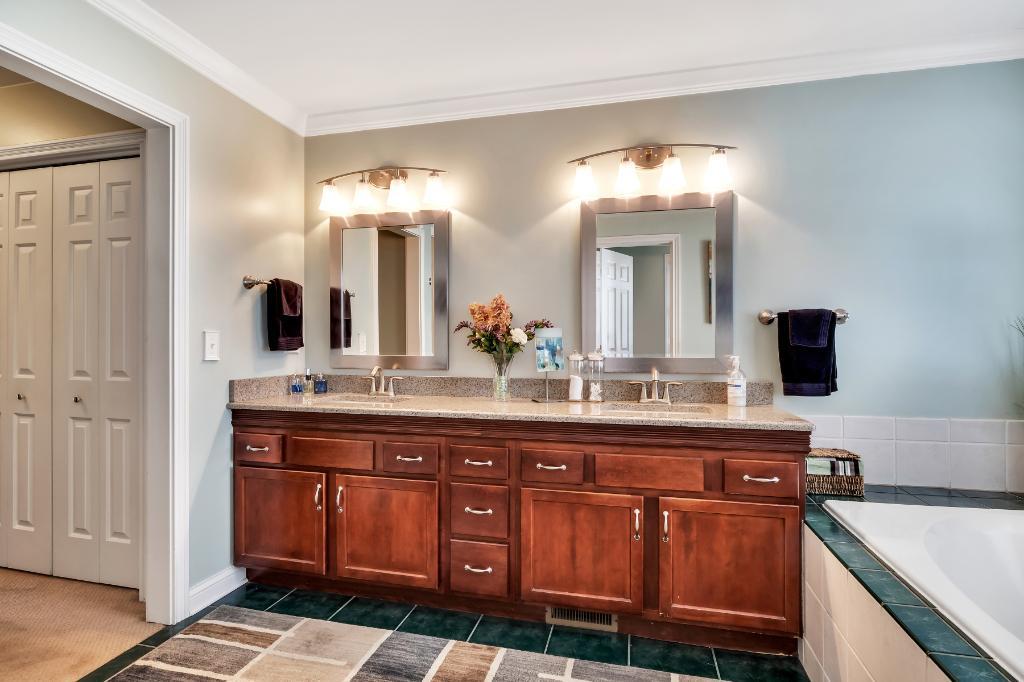 807 Sharp Court Elburn, IL 60119 - Photo 25 of 44 a spacious bathroom with a double vanity sink and a mirror