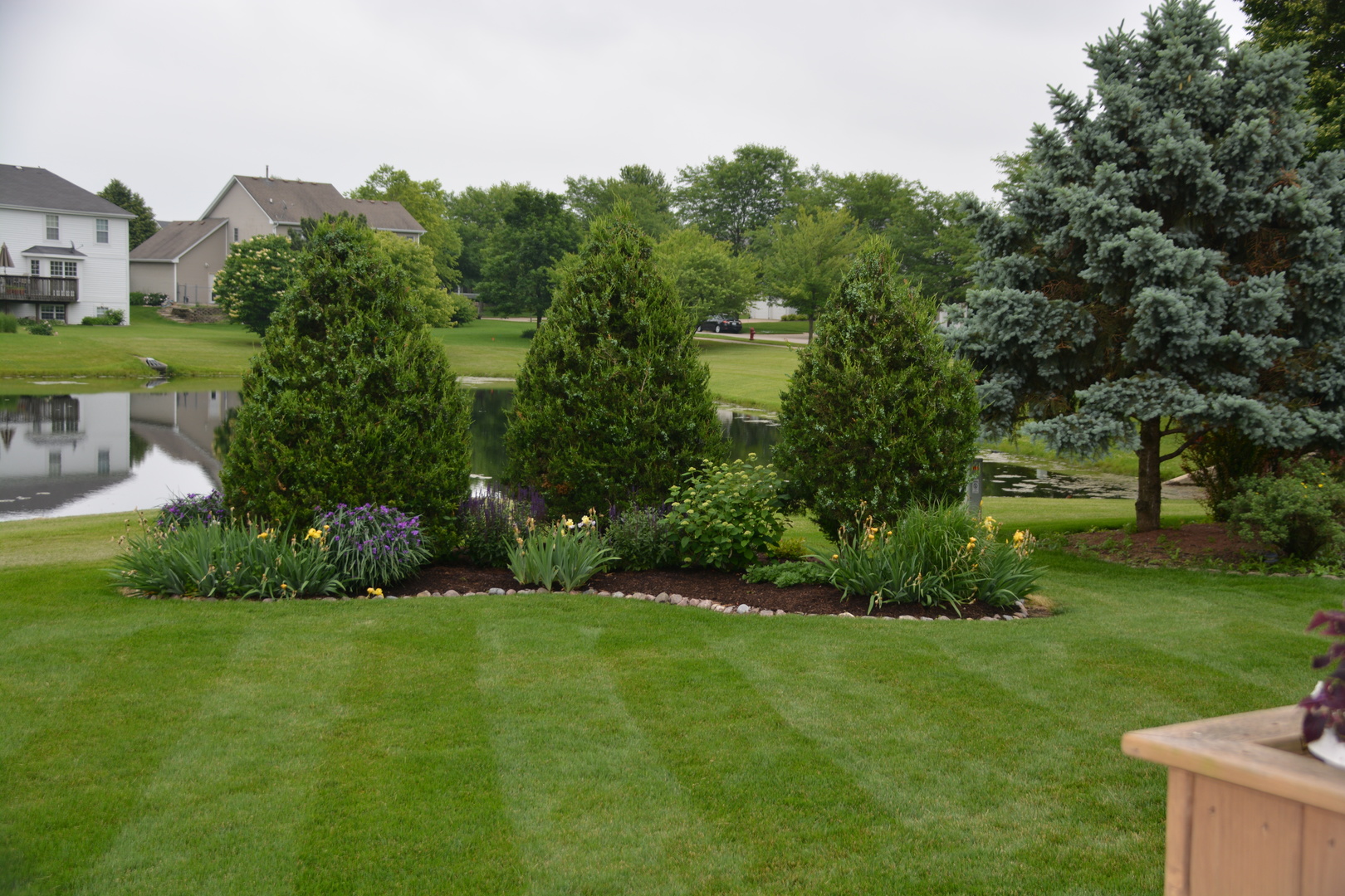 807 Sharp Court Elburn, IL 60119 - Photo 40 of 44 a view of a garden with a building in the background