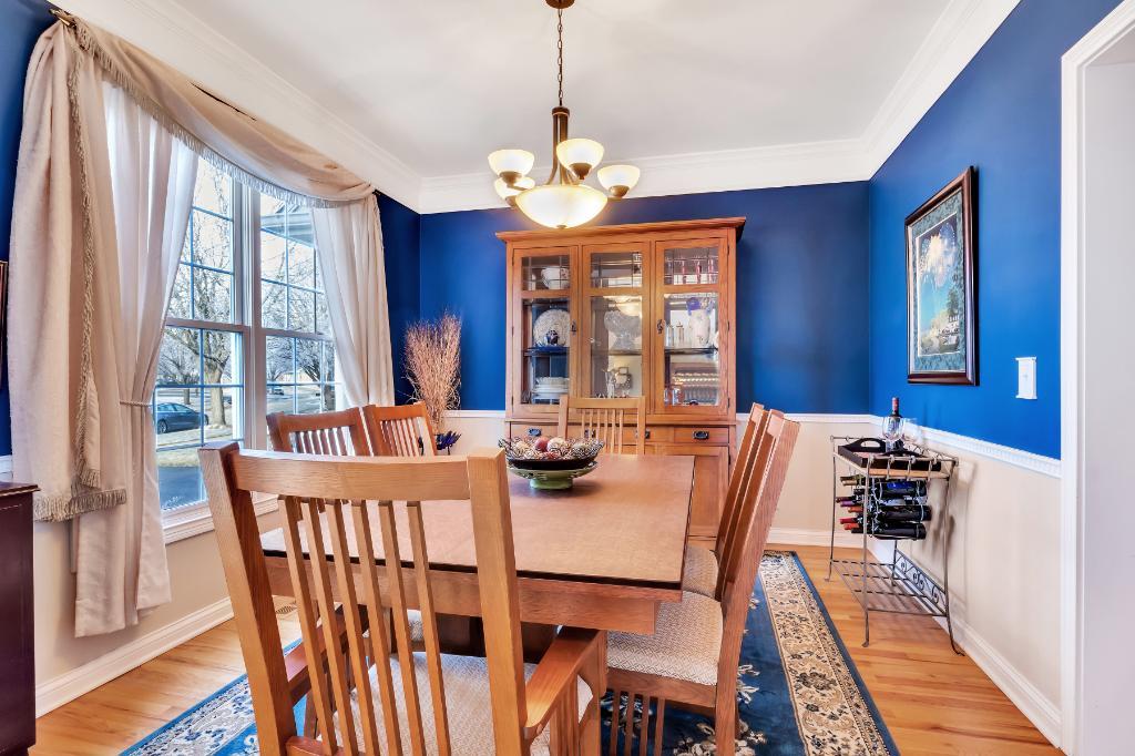 807 Sharp Court Elburn, IL 60119 - Photo 7 of 44 a view of a dining room with furniture wooden floor and a chandelier