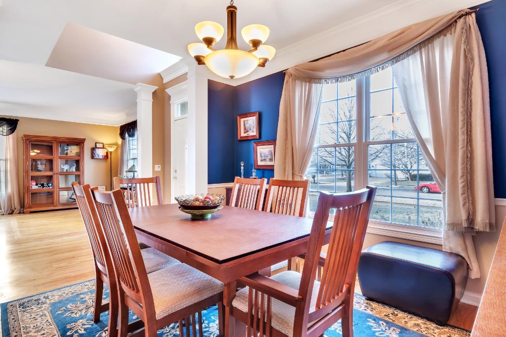 807 Sharp Court Elburn, IL 60119 - Photo 9 of 44 a view of a dining room with furniture window and wooden floor