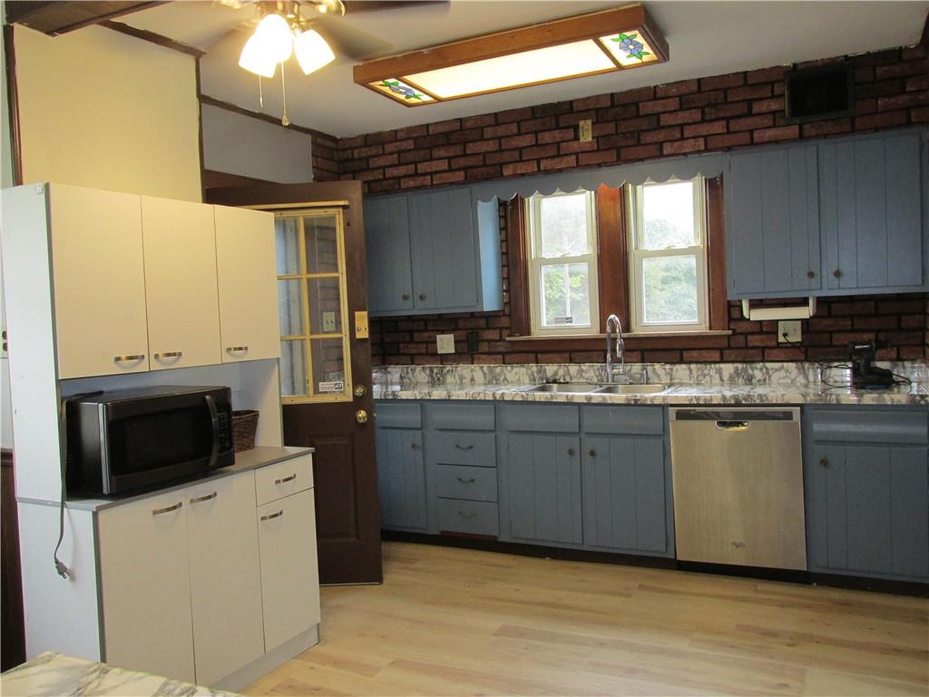 3245 Middletown Road Pittsburgh, PA 15204 - Photo 8 of 24 a kitchen with stainless steel appliances granite countertop a stove a sink and a microwave