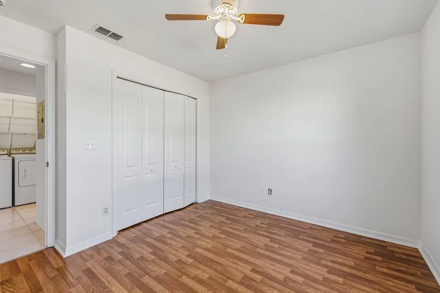 a view of empty room with wooden floor