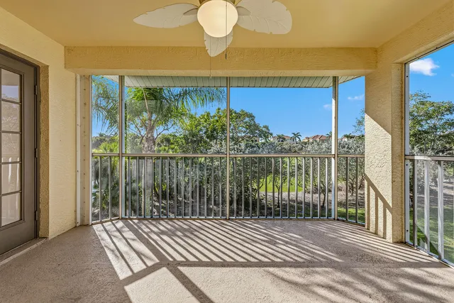 a view of a balcony with wooden floor and fence