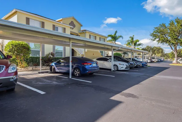 a sign that is sitting in front of a tree