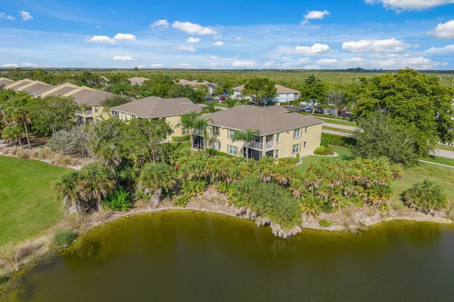 an aerial view of residential houses with outdoor space and river