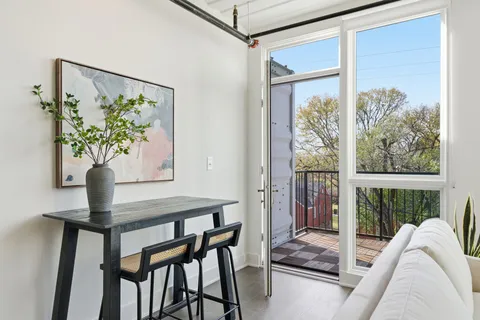 a view of a livingroom with furniture and a potted plant