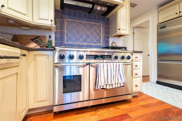 a kitchen with stainless steel appliances granite countertop a stove and a refrigerator