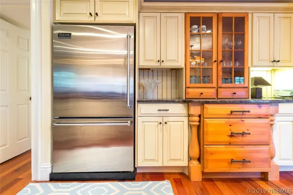 a close view of walk in closet with wooden floor